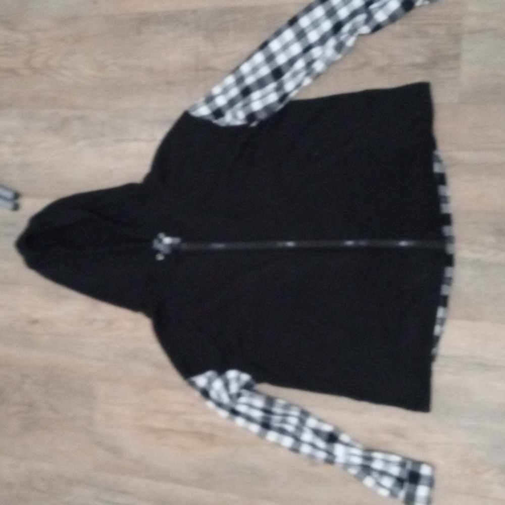 I am selling a black and white partially plaid sweater.